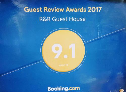 a sign that reads quest review awards rr guest house at R&R Guest House in Pokhara