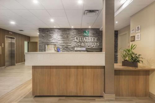 a lobby of a university hospital with a reception counter at Quality Inn & Suites Windsor - Downtown in Windsor