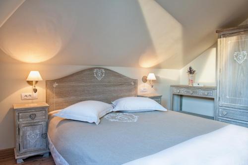a bedroom with a large bed with two night stands at Chalet Hovel in Mănăstirea Humorului