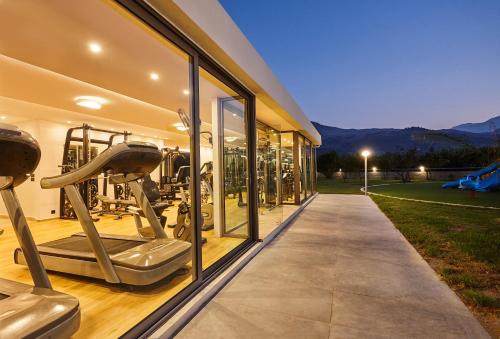 an indoor gym with fitness equipment in a building at Anna's House in Georgioupolis