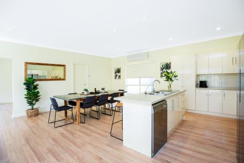 a kitchen with a table and chairs in a room at Aldinga Beach Experience - C21 SouthCoast Holidays in Aldinga Beach