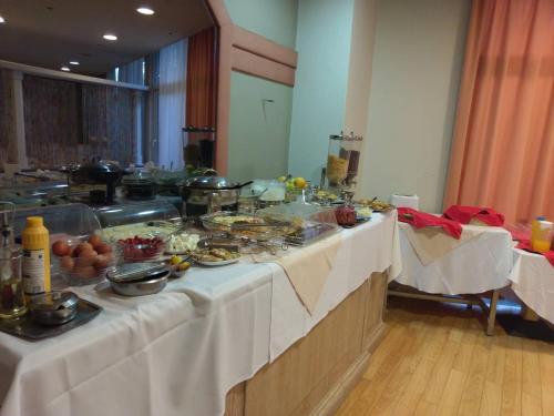 a table with food on it in a room at Park Hotel in Athens