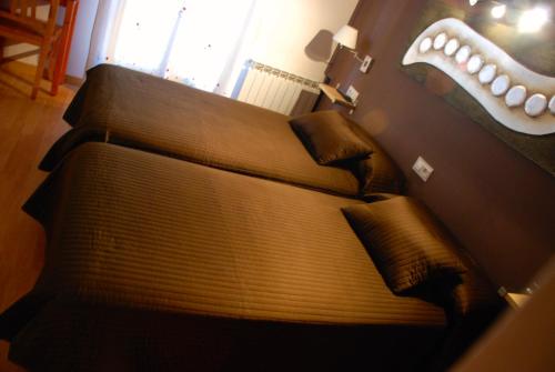 a couch in a living room with a mouth on the wall at Hostal Delgado in Benabarre