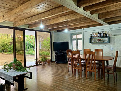 a dining room with a table and chairs and a television at Old City Hotel in Kutaisi