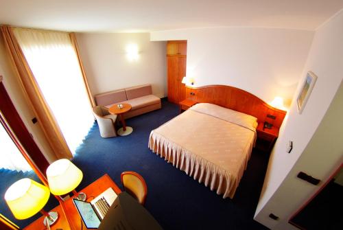 a hotel room with a bed and a desk at Hotel Villa Marija in Tučepi