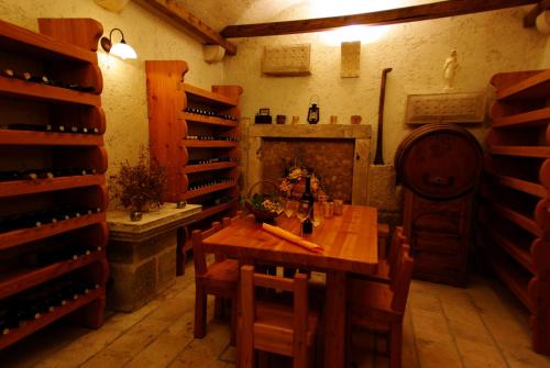 a dining room with a wooden table and wine racks at Hotel Villa Marija in Tučepi