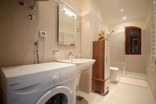 La salle de bains est pourvue d'un lave-linge et d'un lavabo. dans l'établissement St.George Apartments, à Petrovac na Moru