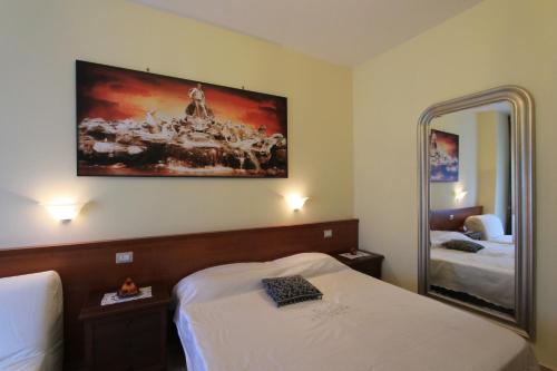 a hotel room with two beds and a mirror at Le Terrazze Del Vaticano in Rome