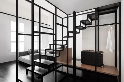a room with a staircase with a suitcase in it at Hotel Mono in Singapore