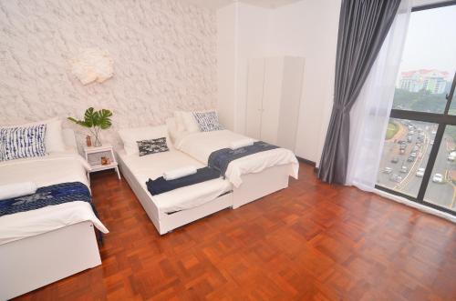 เตียงในห้องที่ New Riverbank Suites - Waterfront Kuching City