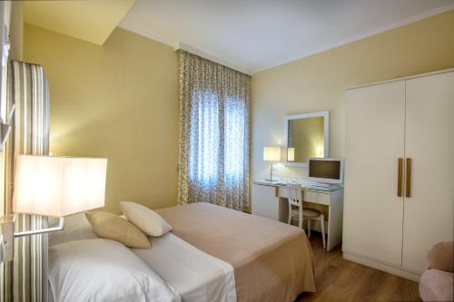 a hotel room with a bed and a desk at Boutique Hotel Regina in Sorrento