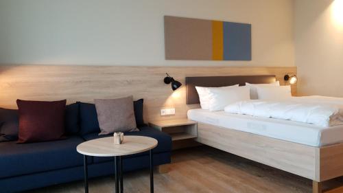 a hotel room with a bed and a couch at Die Sandburg in Langeoog