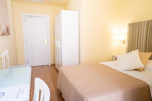 a small room with a bed and a door at Boutique Hotel Regina in Sorrento