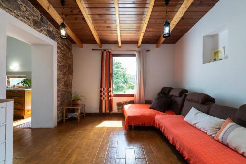 a living room with a couch and a window at Villa Canaria piscina jacuzzi jardín in Santa Maria de Guia de Gran Canaria