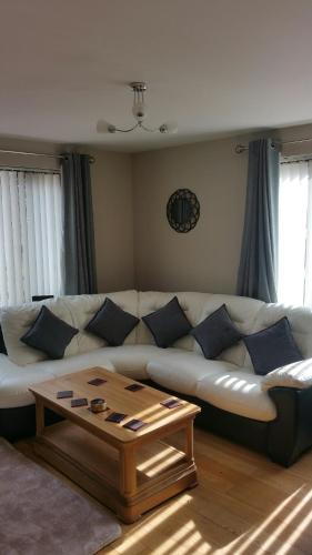 a living room with a white couch and a coffee table at The Cobblers in Inverness