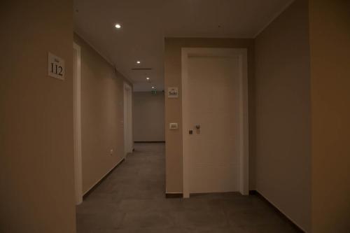 an empty hallway with a white door in a building at Onorati Hotel in Priverno