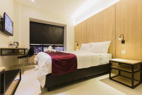 a hotel room with a bed and a large window at GM Hotel Kuantan in Kuantan