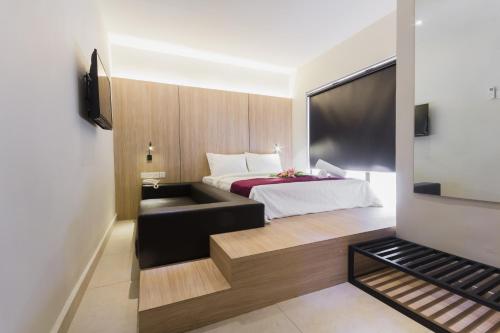 a hotel room with a bed and a couch at GM Hotel Kuantan in Kuantan