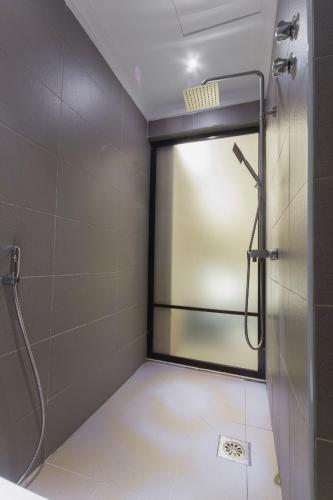 a shower with a glass door in a bathroom at GM Hotel Kuantan in Kuantan