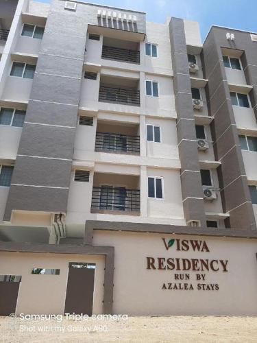 a building with a sign in front of it at Viswa Residency by Azalea in Madurai