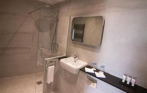 a bathroom with a sink and a shower at The Marine Boutique Hotel in Ballybunion