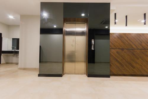 a elevator in a building with a wooden door at GM Hotel Kuantan in Kuantan