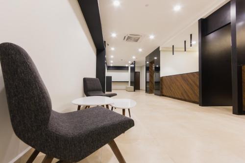 a room with two chairs and a table at GM Hotel Kuantan in Kuantan