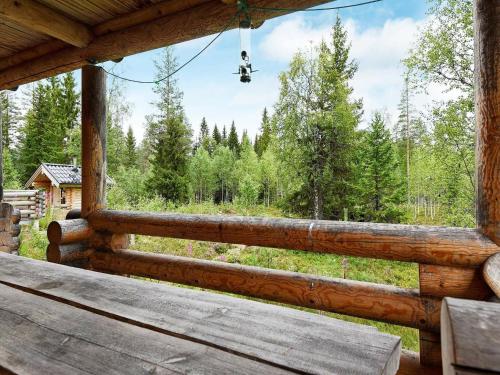 a porch of a cabin with a view of a forest at 7 person holiday home in S LEN in Tandådalen