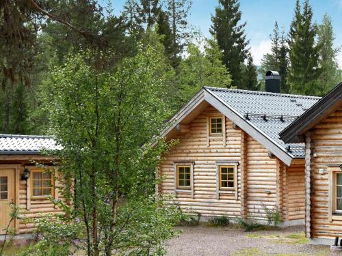 a log cabin with a tree in front of it at 6 person holiday home in S LEN in Tandådalen