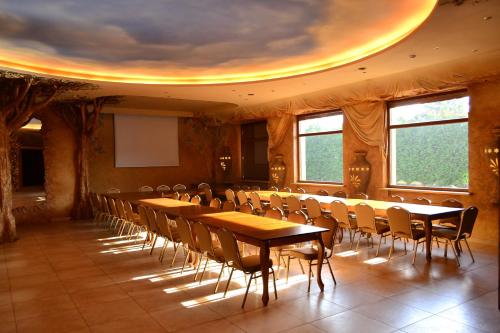 a conference room with wooden tables and chairs at Hotel Księcia Józefa in Poznań
