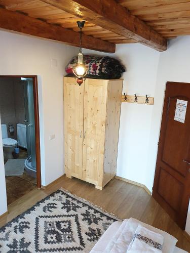 a room with a bed and a wooden cabinet at Popas in Breb in Breb