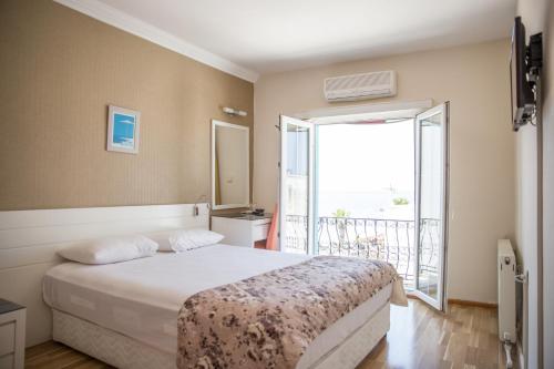 Ένα ή περισσότερα κρεβάτια σε δωμάτιο στο Kortan Hotel