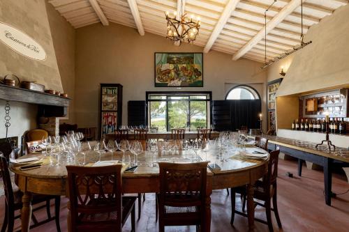 a large dining room with a large table with wine glasses at Casanova di Neri Relais in Montalcino