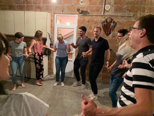 a group of people standing in a kitchen at Karine B&B in Yeghegnadzor