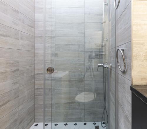 a shower with a glass door in a bathroom at Apartman Ambasador Zagreb in Zagreb