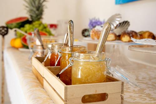 a kitchen counter with jars of honey and vegetables at B&B Cantiere dell'anima - Rooms of art in Trapani