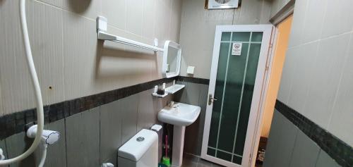 a bathroom with a toilet and a sink at Surf Deck in Thulusdhoo