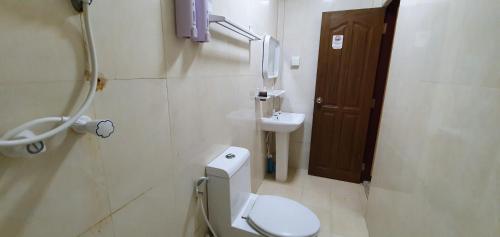a bathroom with a toilet and a sink at Surf Deck in Thulusdhoo