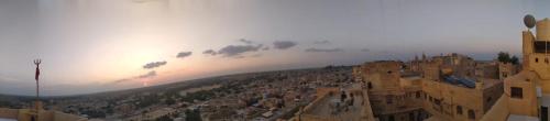 a view of a city with the sunset in the background at Fort Villa in Jaisalmer
