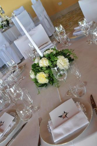 a table with white flowers and glasses on it at Hotel Villa Pina Antico Francischiello in Massa Lubrense