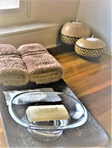 a tray with a plate with a soap on it at Swellendam Country Lodge - Guest House - B&B in Swellendam