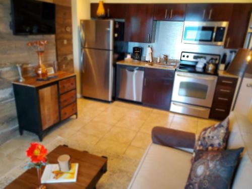 a kitchen with stainless steel appliances and a couch at The Beach on Longboat Key in Longboat Key