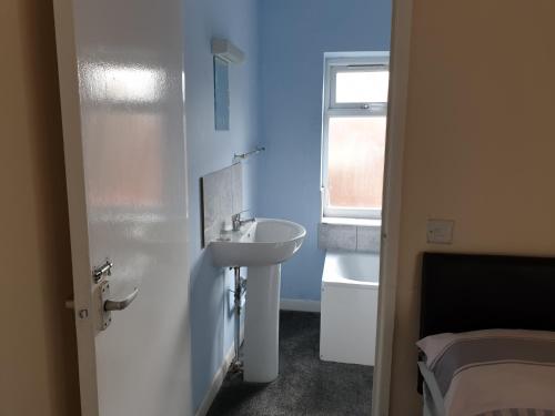 a small bathroom with a sink and a mirror at Tower House Hotel in Reading