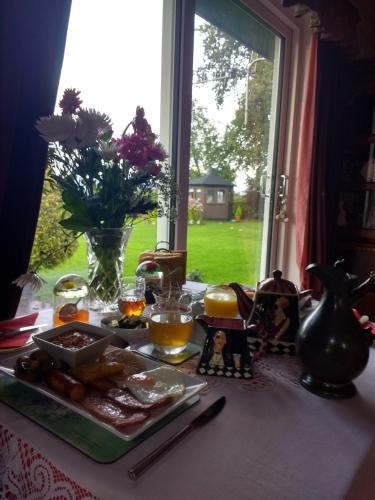 a table with a plate of food and a window at Lower Balwill in Buchlyvie