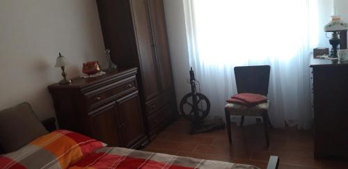 a bedroom with a bed and a dresser and a chair at Ubytování pod Pálavou in Horní Věstonice