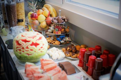 a bunch of different types of food on a table at Hotel Premium in Skopje
