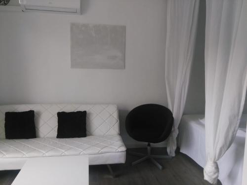 a white couch and a chair in a room at Laura Sunbeach in Alcudia