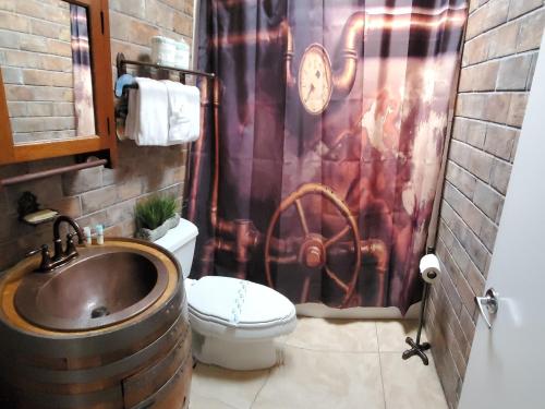 a bathroom with a sink and a shower curtain at The Beach on Longboat Key in Longboat Key
