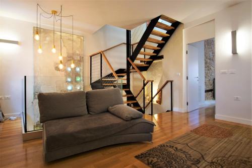a living room with a couch and a staircase at Villa Castel in Bale