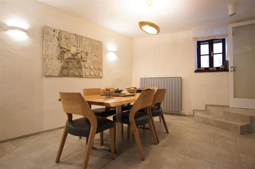a dining room with a wooden table and chairs at Villa Castel in Bale